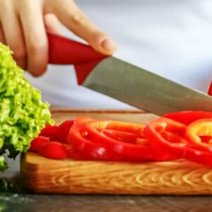 woman-chef-slicing-vegetables-in-the-kitchen-the-2021-09-03-19-41-00-utc-2
